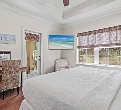 Relax in this airy upstairs bedroom featuring calm coastal d-cor and comfort.