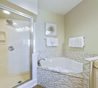 Spacious master bathroom with double vanity, soaking tub, and walk-in shower