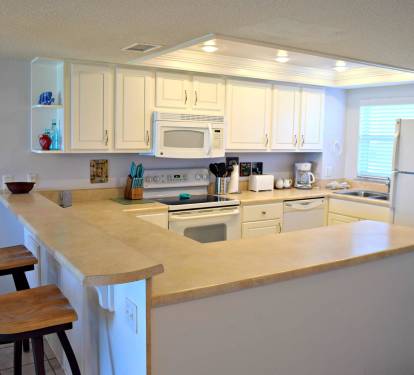 Kitchen with high bar, makes it nice to have company while cooking!