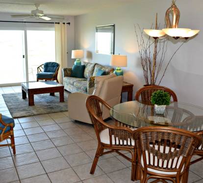 Dining room, living room and sliding glass doors to the beach and pool.