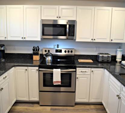 Tile floors, granite counter tops, and new cabinets in this kitchen.