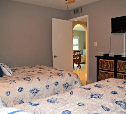 Guest bedroom looking out towards dining, living room, and guest bath.