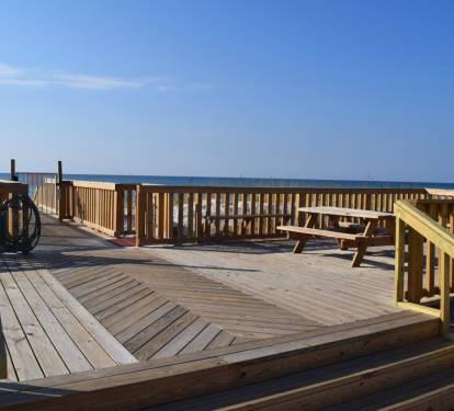 Between the pool and the Gulf - shower, picnic tables with BBQ grills, and just a good spot to check it all out.