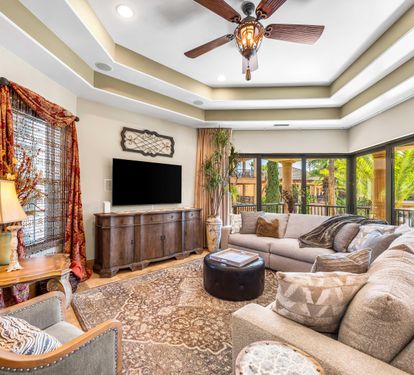 The sophisticated furnishings include a large curved sectional sofa