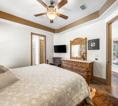 First floor king bedroom with a tray ceiling.