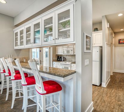 Down the hallway leads to the laundry room on your right, full bathroom on your left & 2 queen bedrooms.