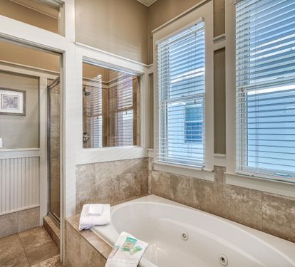 Primary ensuite bathroom with soaking bathtub & separate walk-in shower