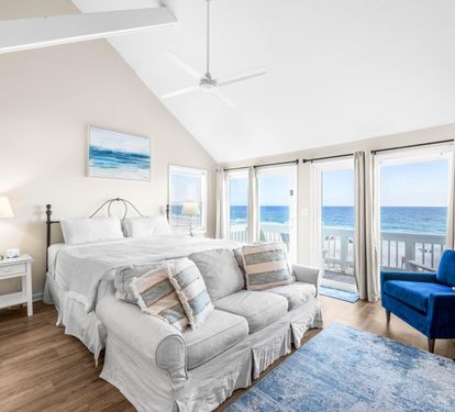 Sleep like royalty—king bed, private balcony, and the soothing sound of ocean waves