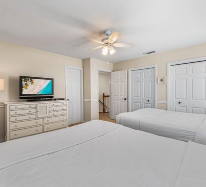 Two queen beds with dresser and 2 closets.