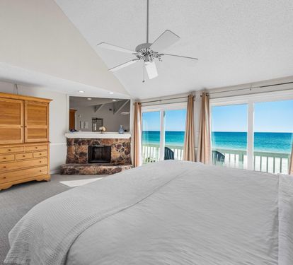 Beachfront primary king bedroom with stunning Gulf views and your private balcony.  40" cable tv located inside the armoir.