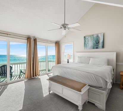 Beachfront primary king bedroom with expansive Gulf views and your private balcony.