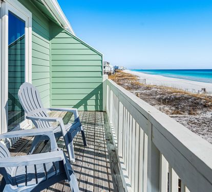 Primary bedroom balcony with views along the coastline.