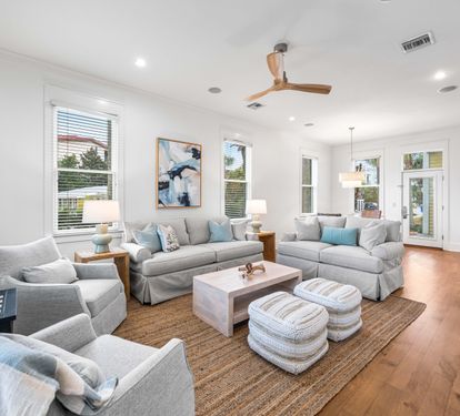 Newly refurbished great room with sisal rug, hardwood floors, shiplap accents & 55" smart tv with YouTube.