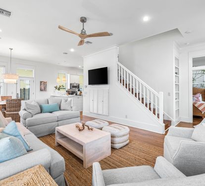 Newly refurbished great room with sisal rug, hardwood floors, shiplap accents & 55" smart tv with YouTube.
