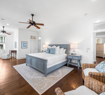 2nd Floor Primary Bedroom with King Bed, 40" YouTube TV, Desk, Walk-in Closet, Ensuite Full Bathroom with Separate Soaking Tub, Walk-in Shower, Double Vanities, & Access to the Covered Balcony with Bistro Tables.
