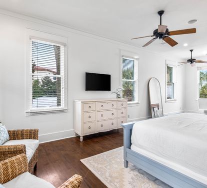 2nd Floor Primary Bedroom with King Bed, 40" YouTube TV, Desk, Walk-in Closet, Ensuite Full Bathroom with Separate Soaking Tub, Walk-in Shower, Double Vanities, & Access to the Covered Balcony with Bistro Tables.