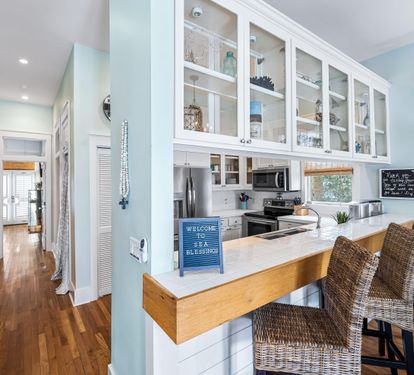 Custom cabinetry and a fully stocked kitchen with  a breakfast bar