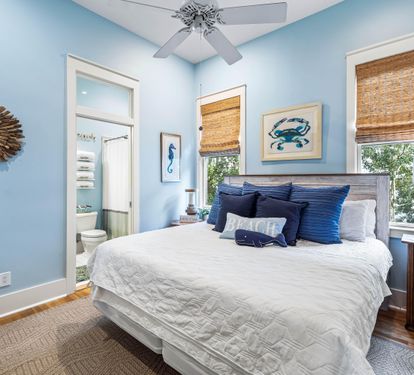 Stylish woven window shades in this serene king bedroom with your en suite bathroom