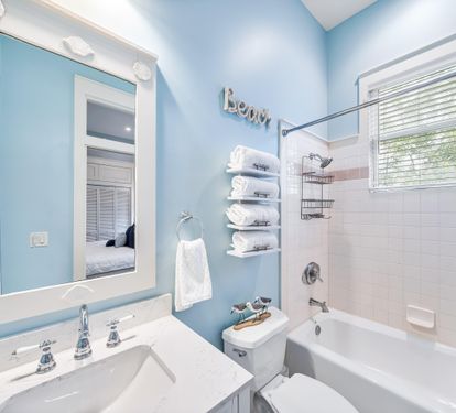 This king bedroom en suite  bathroom has a bathtub and shower combination.