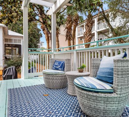 Back deck off  the primary bedroom with barrel shaped wicker seats - a perfect spot for morning coffee.