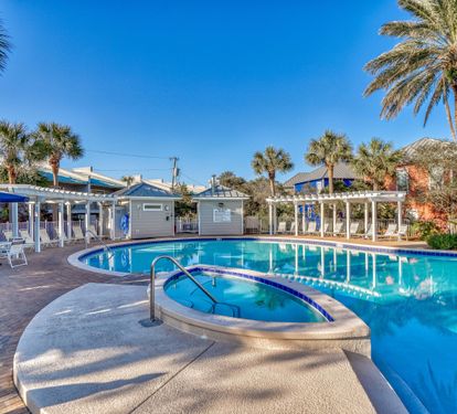 Families enjoy this spacious pool area with plenty of seating for sunbathing plus the heated spa and nearby grilling area.