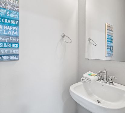 2nd floor half bathroom located in the hallway between the living area & primary bedroom.