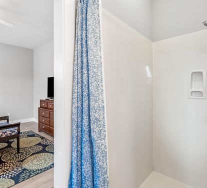 2nd floor ensuite bathroom for the primary king bedroom with double vanities, separate walk-in shower, & soaking bathtub.