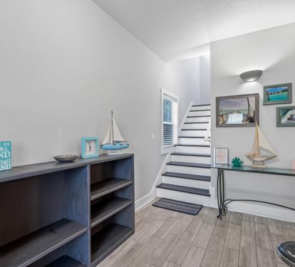 Attractive first floor foyer with game arcade the kids will love.  3 additional bedrooms occupy this first floor.