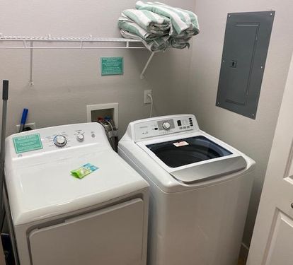 1st floor hall closet opens up with a full size washer and dryer