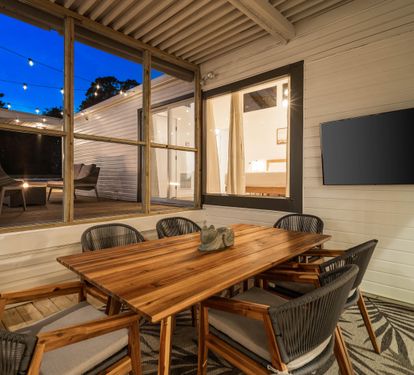 Outdoor Dining on a Covered Screened in Patio with a 58" Smart TV