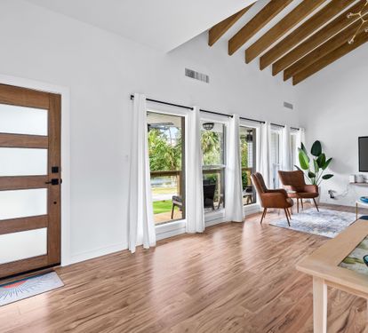 Entry door and living area into a Vaulted Ceiling and Newly Remodeled with a 70" Smart TV with Cable