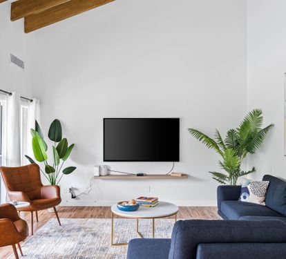 Living room with vaulted ceiling, sectional couch and large flat screen television