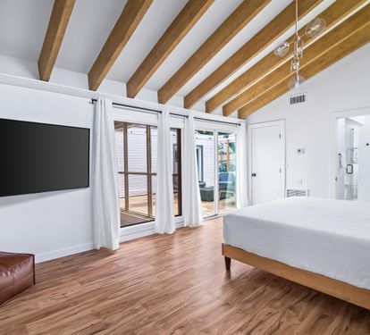 King bed primary bedroom with large flat screen tv and sliding door opening to the pool deck area. Bedroom #1