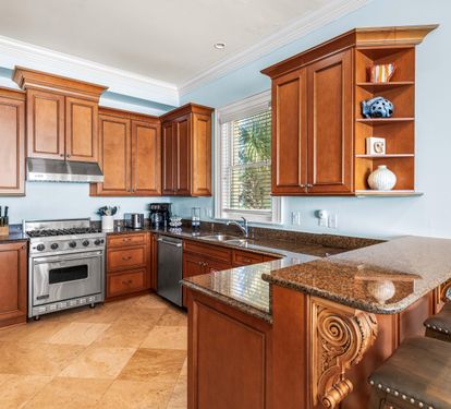 Second Floor Fully Stocked Kitchen with Granite Countertops, Stainless Steel Appliances including Viking Range, KitchenAid Refrigerator, and Under-Counter Ice Maker.