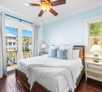Second Floor Bedroom with King Bed, 42" TV, Walk-In Closet, Ensuite Bathroom & Balcony Overlooking the Frangista Beach Community.