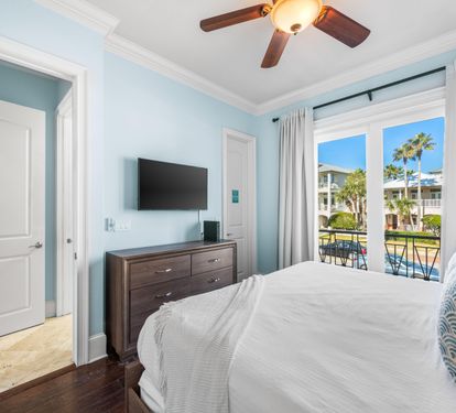 Second Floor Bedroom with King Bed, 42" TV, Walk-In Closet, Ensuite Bathroom & Balcony Overlooking the Frangista Beach Community.