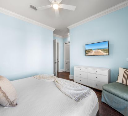 Third Floor Bedroom with King Bed, 40" TV, Ensuite Bathroom with Bathtub/Shower Combination & Balcony Overlooking the Frangista Beach Community.