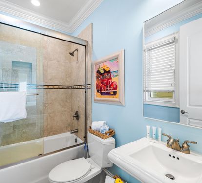 Ensuite Bathtub and Shower Combination with Pedestal Vanity for the first floor king bedroom.
