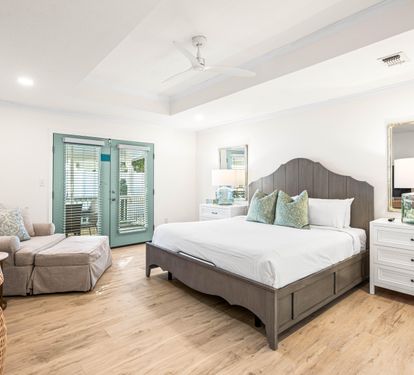 The Primary King Bedroom with Ensuite Soaking Tub, Double Vanity and Walk in Shower, Nightstands, Large Dresser and Comfy Large Chair and Ottoman. 55" Smart TV with Cable.