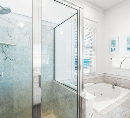 Walk-in shower and a large jetted soaking tub in this primary beachfront bathroom.