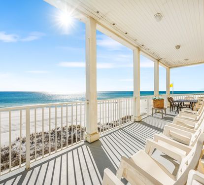 Rocking chairs plus an outdoor dining table on this 2nd floor balcony!