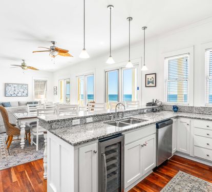 Open kitchen on the 2nd floor level great room with stainless steel double sinks, wine cooler, dishwasher & granite countertops.
