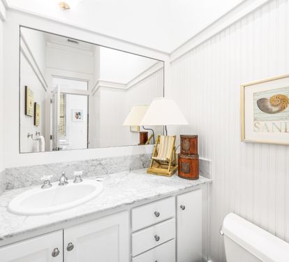 Freshen up in this pristine half bathroom on the 2nd floor level just off the great room.