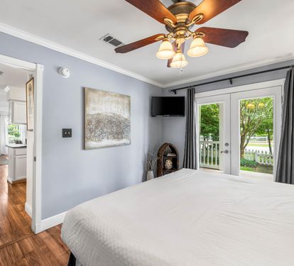 King Bedroom #1 on first floor with porch access and 32" smart tv