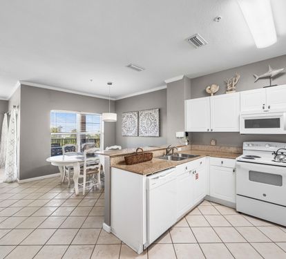 Fully Stocked Kitchen with Bar Seating for 3 and Dining Area