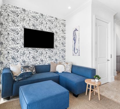 Second Floor Living area with Two Sectional Sofa's Offering a Better Seating Space. A Large Smart TV to Catch all the Favorite's
