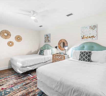 East end of Seabreeze has a 2nd bedroom with 2 queen beds & adjacent full bathroom with a walk-in shower.   TV located above the chest of drawers