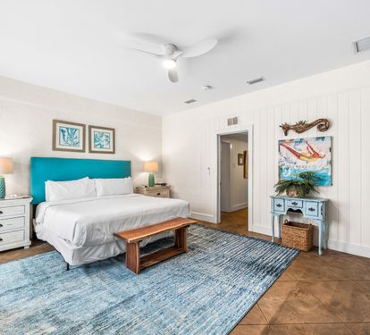 3rd Bedroom is the primary suite on the east end with a king bed, 45" TV,  walk-in closet, ensuite full bathroom with a bathtub/shower combination, and views of the pool area & door leading out to the pool.  (safety alarm on door)