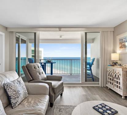 Relax in your oceanfront living room where stunning sea views frame your perfect beach getaway through expansive glass doors.
