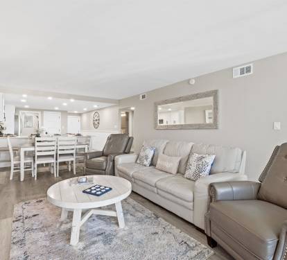 Relax in your stylish open-plan living space with plush leather seating and modern coastal touches throughout.